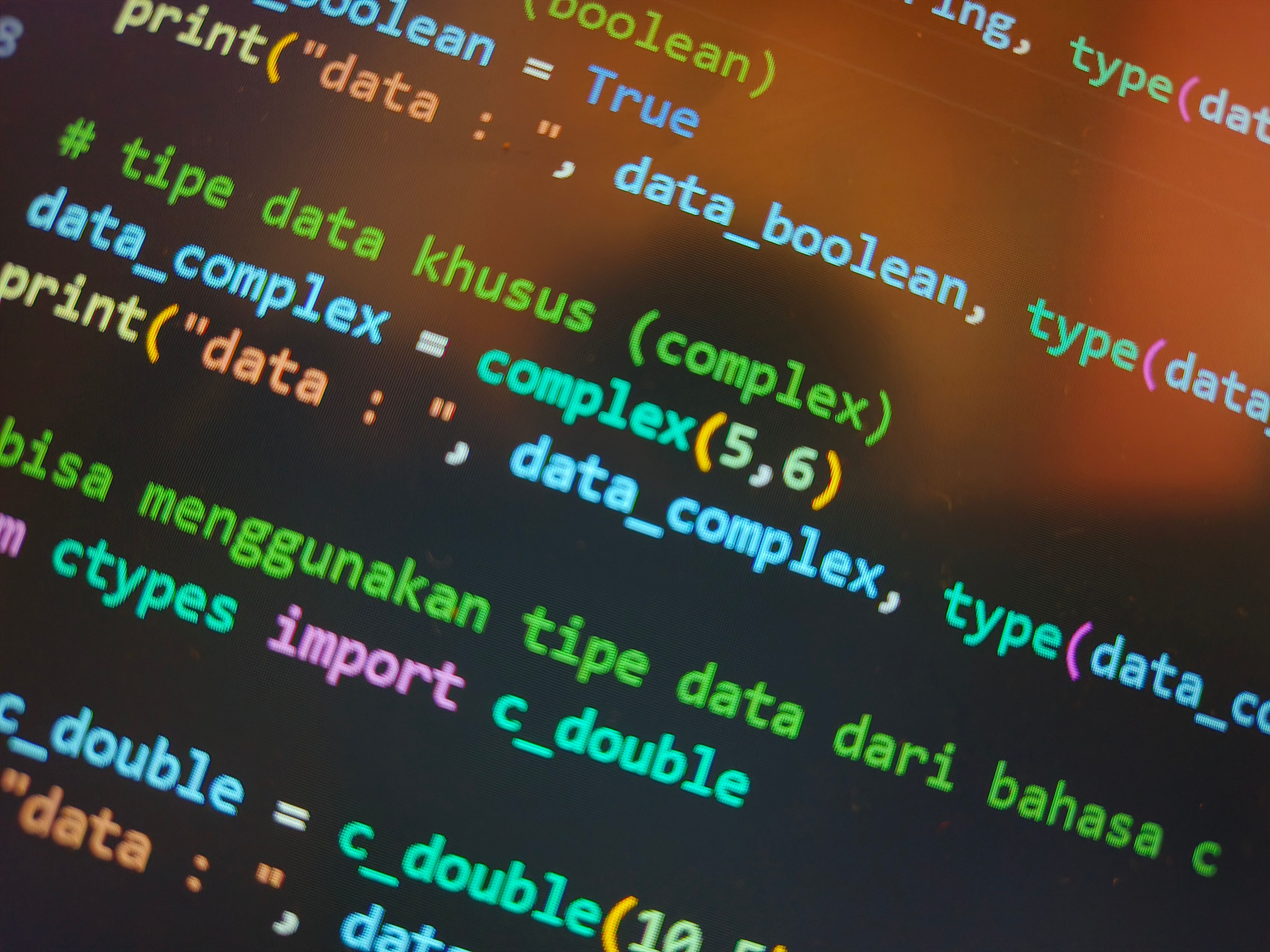 A laptop screen displaying lines of HTML code